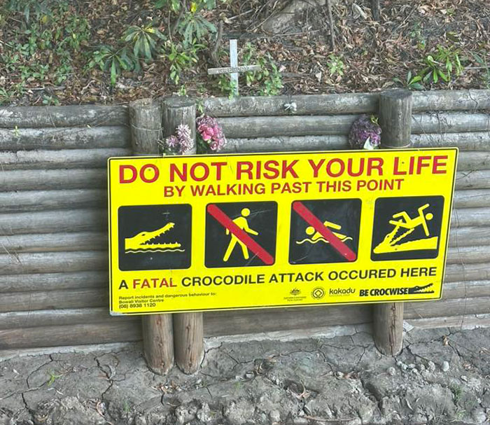 Warning sign about fatal crocodile attack and dangers near river where man and child were fishing sparking heated reactions Warning sign about fatal crocodile attack and dangers near river where man and child were fishing sparking heated reactions