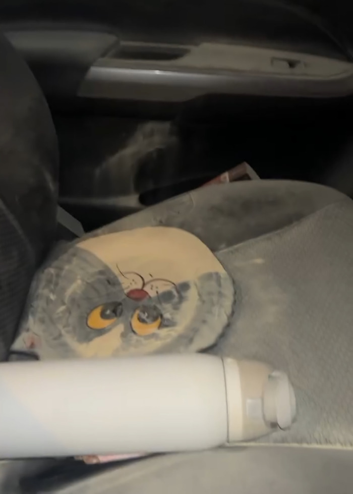 Car seat covered in fire extinguisher residue next to a child's toy, related to 5-month-old baby hospital incident.