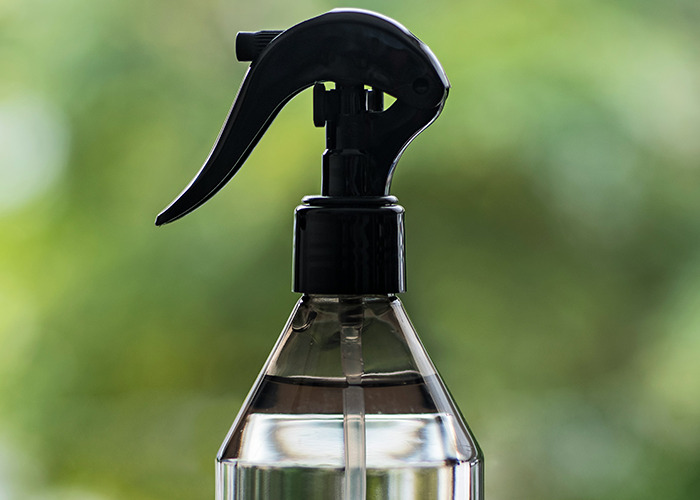 Close-up of a spray bottle with clear liquid, representing habits that may improve your quality of life.