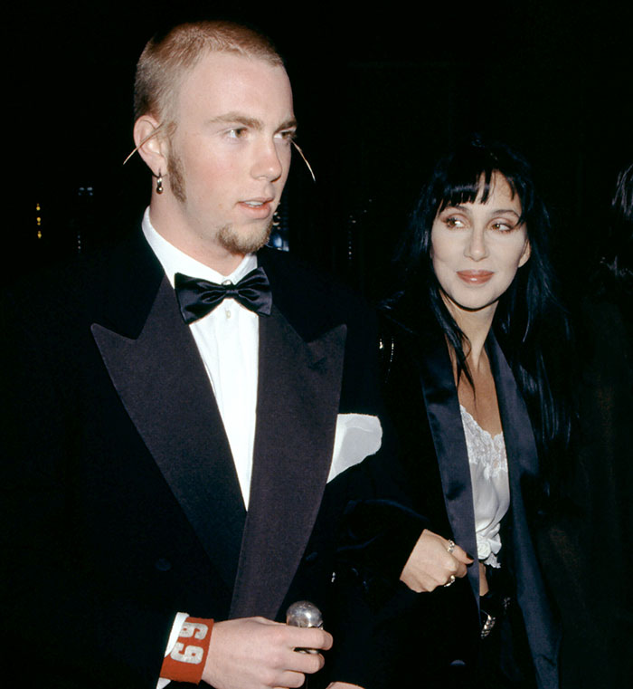 Cher attending a formal event with her son, highlighting the emotional impact of alleged kidnap attempts and overdose struggles.