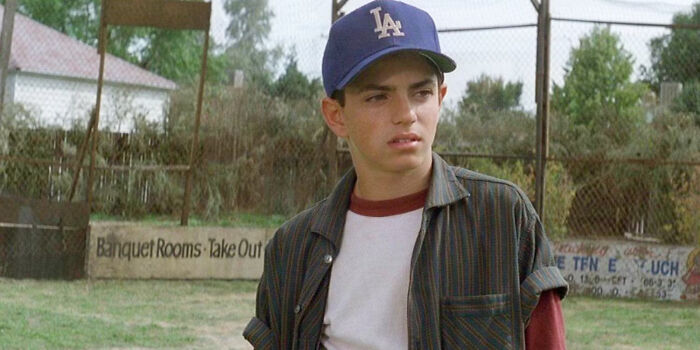 Young former Hollywood star wearing a baseball cap on a field, representing stars who left the spotlight for normal careers.