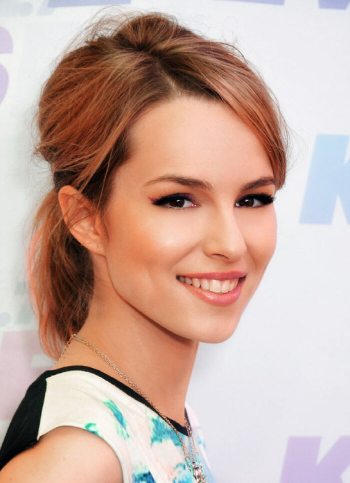 Close-up of a smiling former Hollywood star with light brown hair, representing former Hollywood stars who gave up the spotlight.