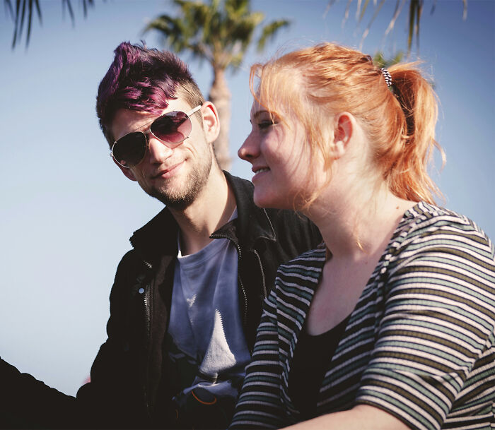 Two friends outdoors with palm trees in background, capturing moments people realized their close friend was a jerk.