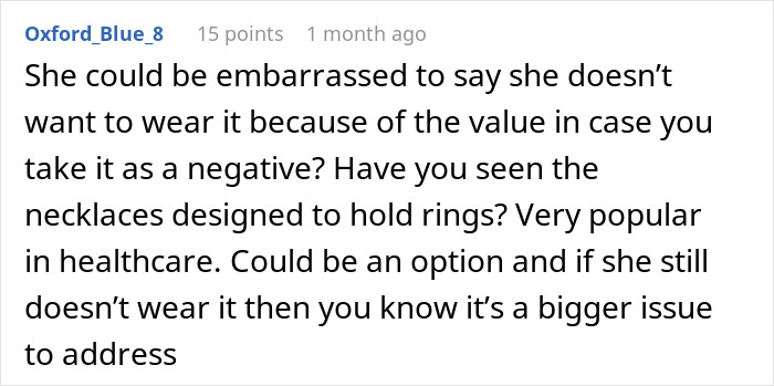 Reddit comment discussing a woman refusing to wear an engagement ring and alternative ring-wearing options. Reddit comment discussing a woman refusing to wear an engagement ring and alternative ring-wearing options.