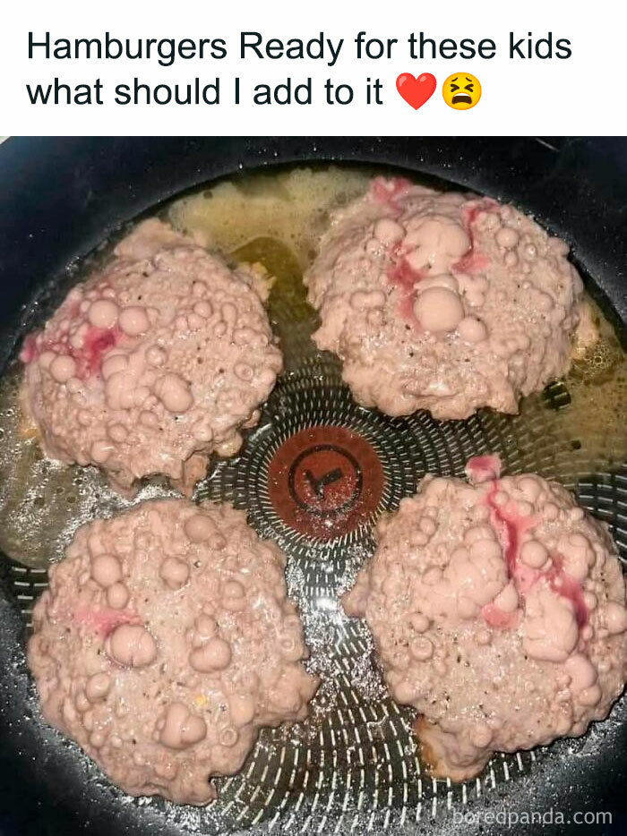 Undercooked burgers bubbling in a frying pan, showcasing one of the gross foods that might lose your appetite for a week.