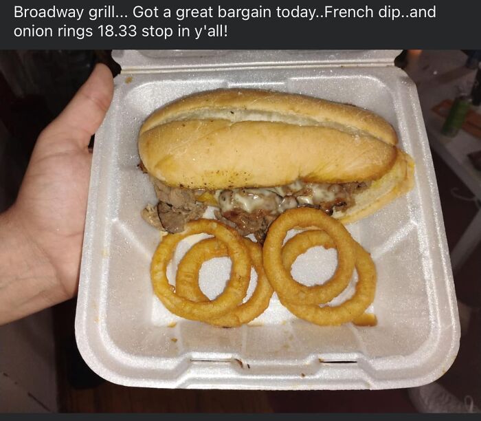 French dip sandwich with melted cheese and crispy onion rings in a takeout container, representing unusual gross foods.
