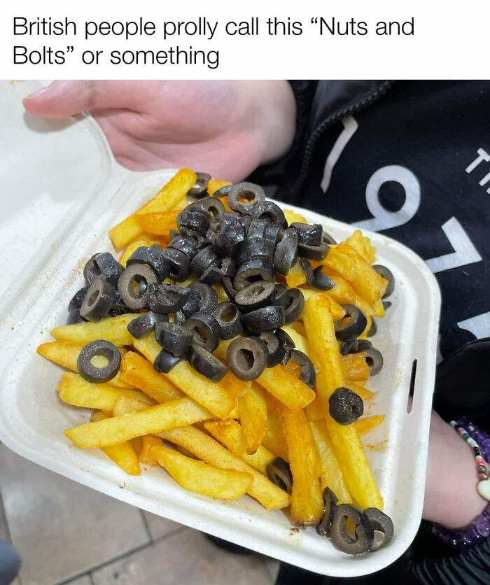Fries topped with a large pile of sliced black olives, an example of gross foods that might lose your appetite.