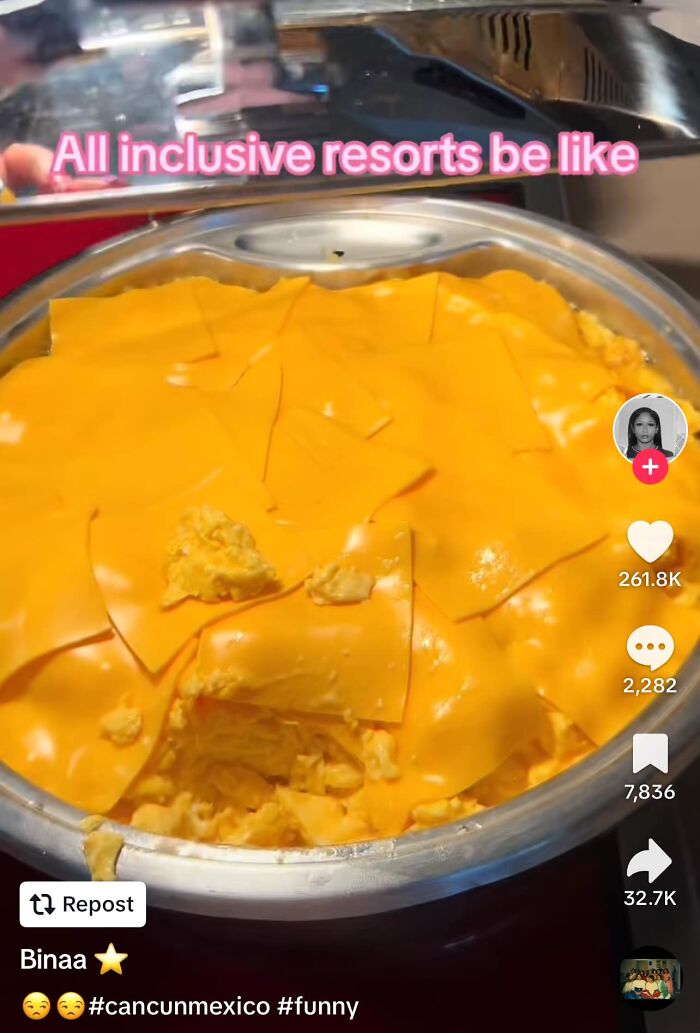 Scrambled eggs covered with processed cheese slices in a buffet tray, illustrating gross foods that might lose appetite.