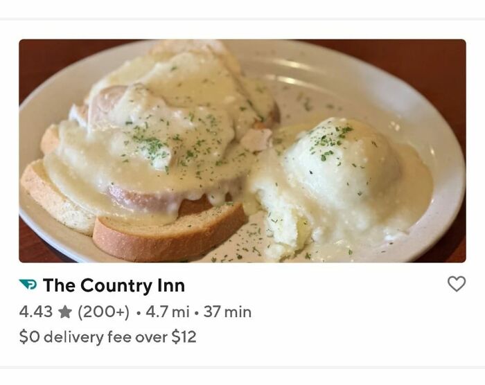 Plate of food featuring white gravy-covered bread and eggs, representing some of the gross foods that might lose your appetite.