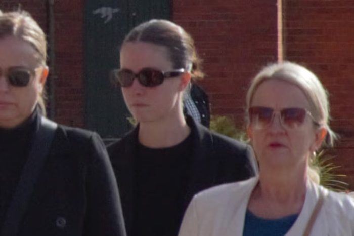 Woman wearing dark sunglasses walking outside with two other women, related to misogynistic comment case and lighter sentence request.