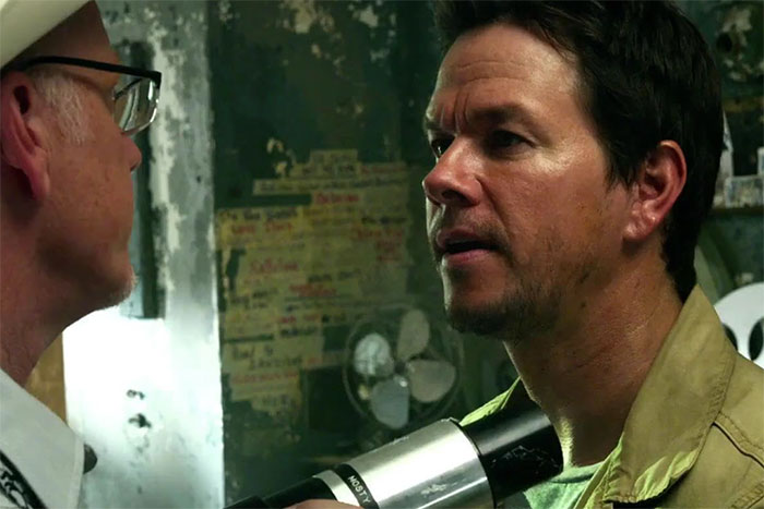 Two men in close conversation in a dimly lit room, illustrating wild rumors about celebrities.