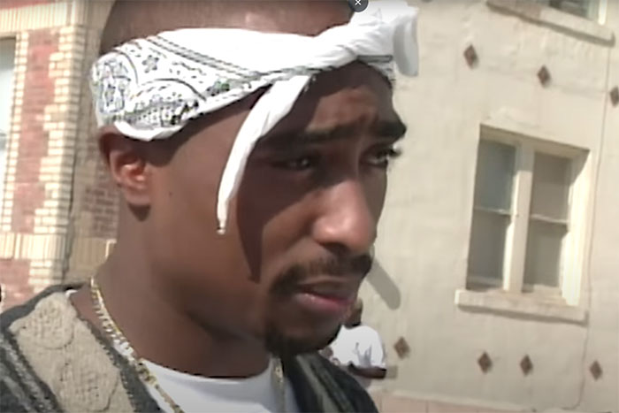 Close-up of a man wearing a white bandana outdoors, related to wild rumors going around about celebrities.
