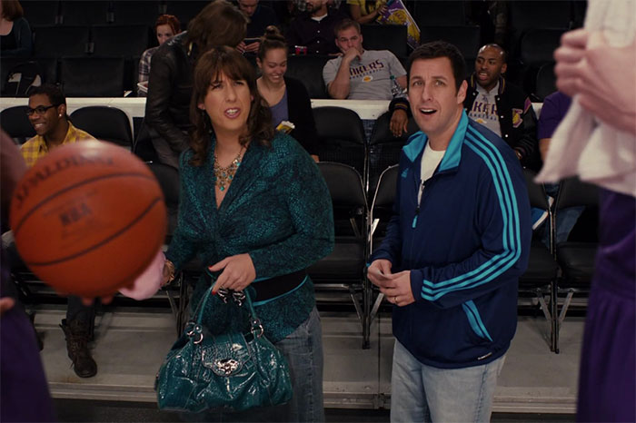 Two people standing courtside at a basketball game, capturing the wildest rumors going around about celebrities.