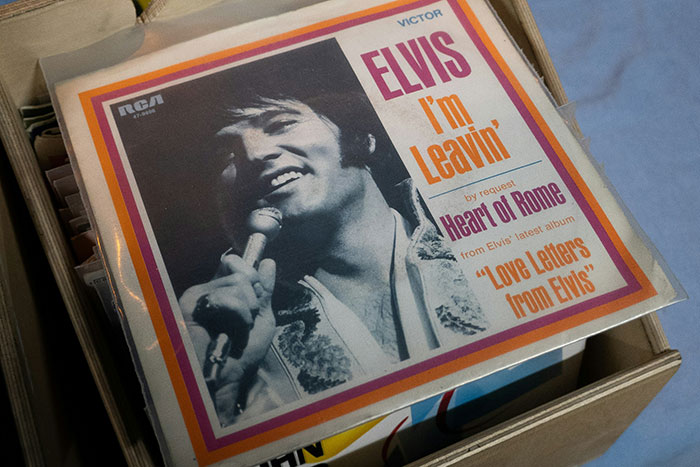 Vintage Elvis record "I'm Leavin'" in a box, evoking nostalgic celebrity rumors and iconic music moments.