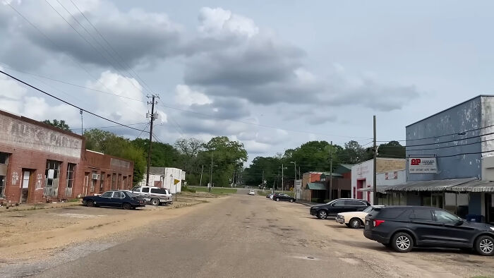 Abandoned small town street with old buildings and parked cars, a creepy and chilling spot in the U.S.
