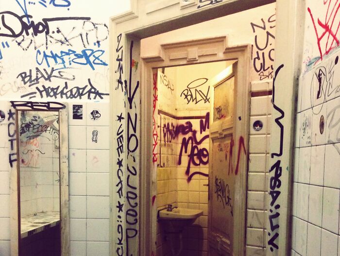Graffiti-covered grimy bathroom in a creepy and chilling spot in the U.S. that visitors regret visiting.