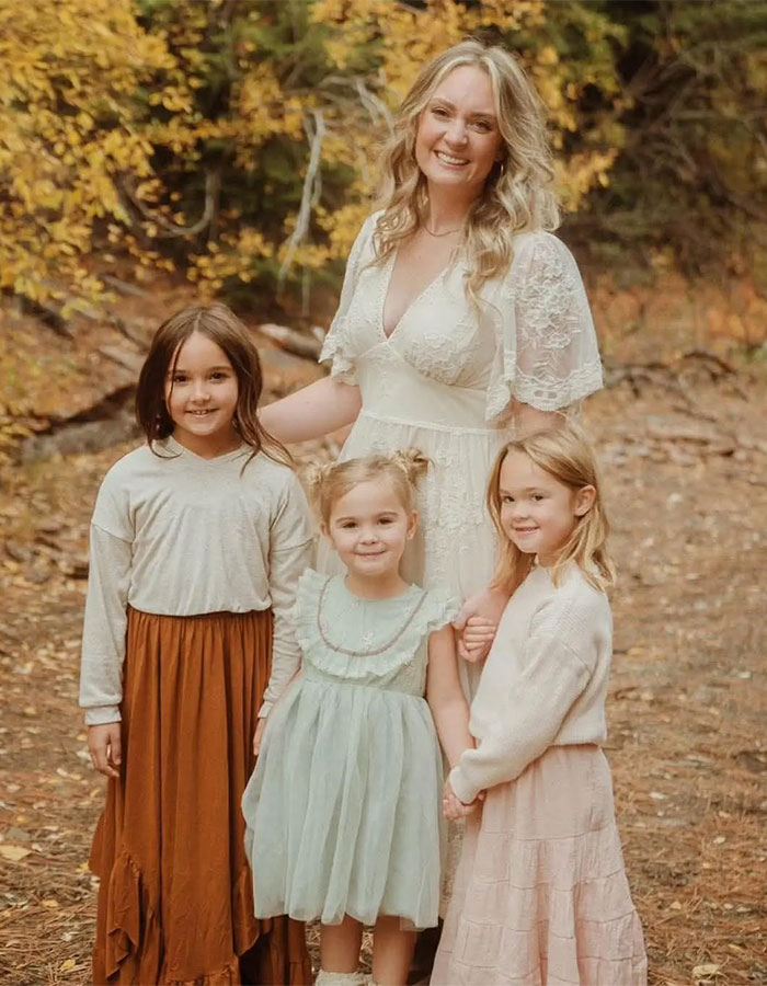 Mother with three daughters outdoors in autumn, related to police investigation of dad who suffocated three daughters.