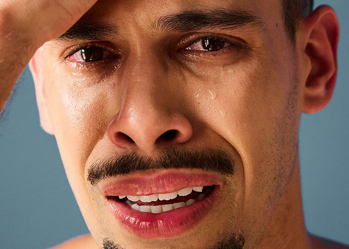 Close-up of a crying man showing raw emotion after discovering the kids were not biologically theirs.