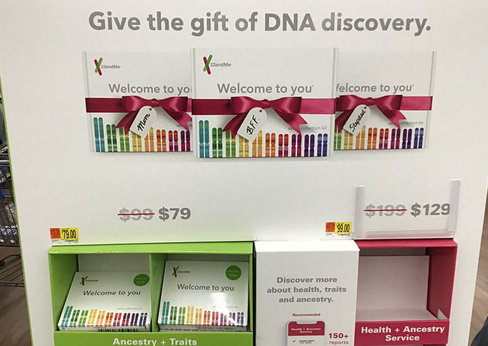 Display of DNA discovery kits with pricing, highlighting ancestry and traits for delivery room paternity testing.