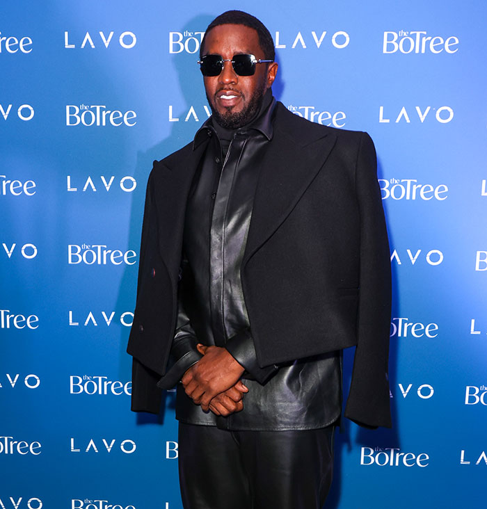 Diddy wearing sunglasses and a black leather outfit at a public event revealing an aged look amid court trial claims.