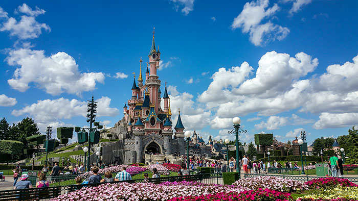 Disneyland wedding scene with castle and visitors, highlighting moment staff notice bride was a 9-year-old girl.