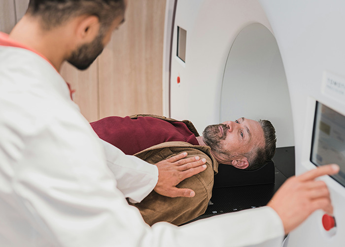 Doctor preparing a male patient for a medical scan, illustrating bizarre medical cases involving unusual skin conditions.
