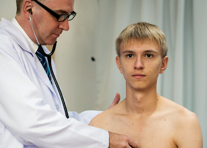Doctor using stethoscope to examine a young male patient during a checkup for medical conditions that surprised doctors