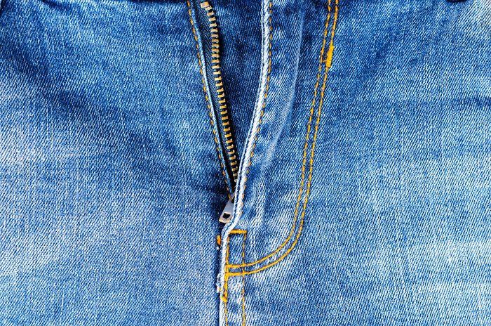 Close-up of blue jeans zipper and stitching details, illustrating a casual and creative style inspired by art teachers online sharing kids' creative freedom.