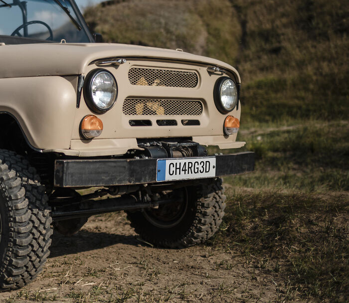 Front view of an off-road vehicle tire and bumper outdoors, illustrating kids' creative freedom in art teachers online sessions.