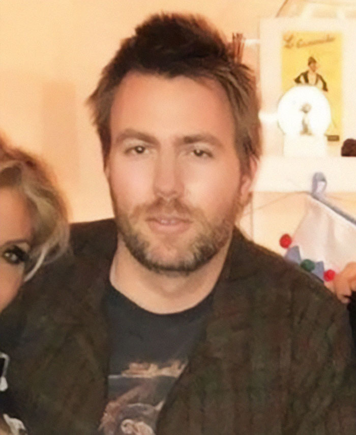 Man with short brown hair and beard wearing a dark shirt indoors related to Cher&rsquo;s son near-fatal overdose news.