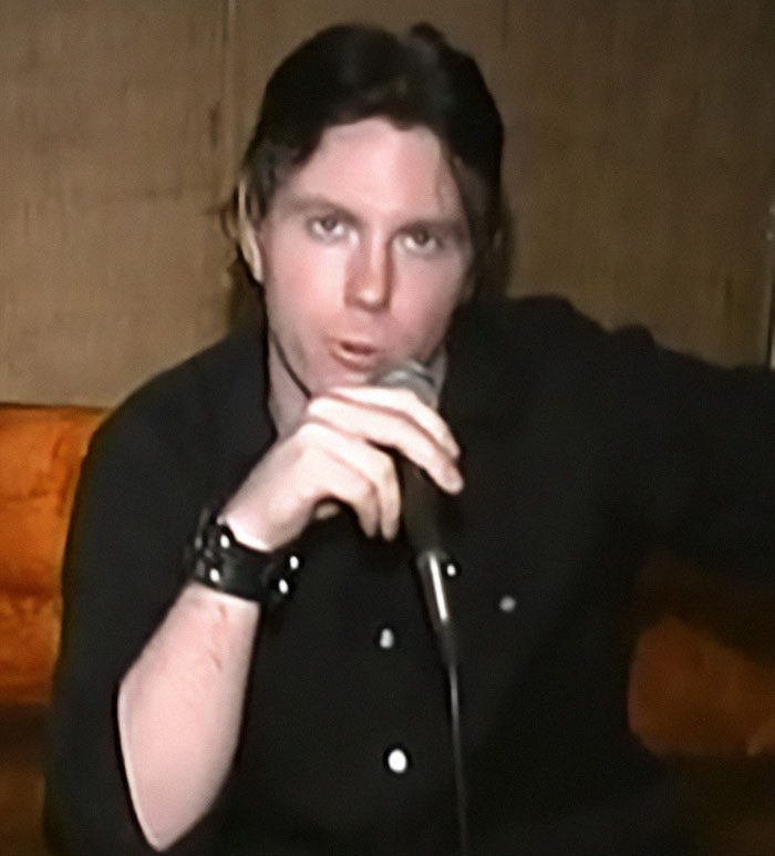 Young man holding microphone in dark shirt, related to Cher suffers massive blow amid son&rsquo;s near-fatal overdose.