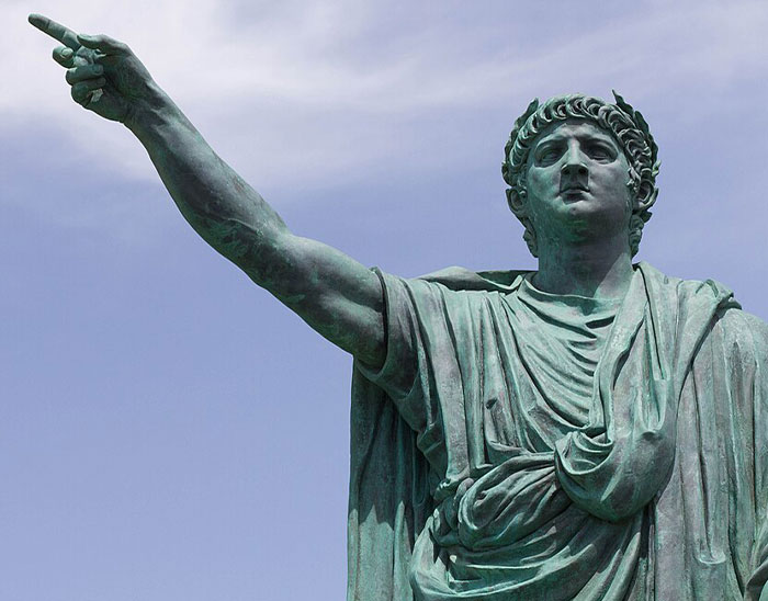 Statue of a Roman emperor pointing forward under blue sky, illustrating common historical knowledge errors.