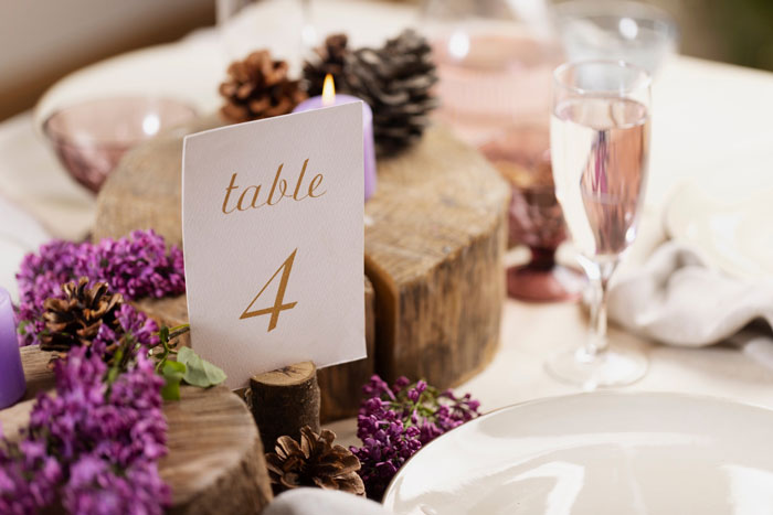 Wedding table setting with floral decorations, highlighting mother of ring bearer left off guest list despite RSVP and help
