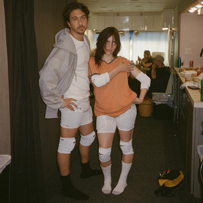 Couple in casual sportswear posing indoors, illustrating the trend of famous lesbians who have gotten boyfriends this year.