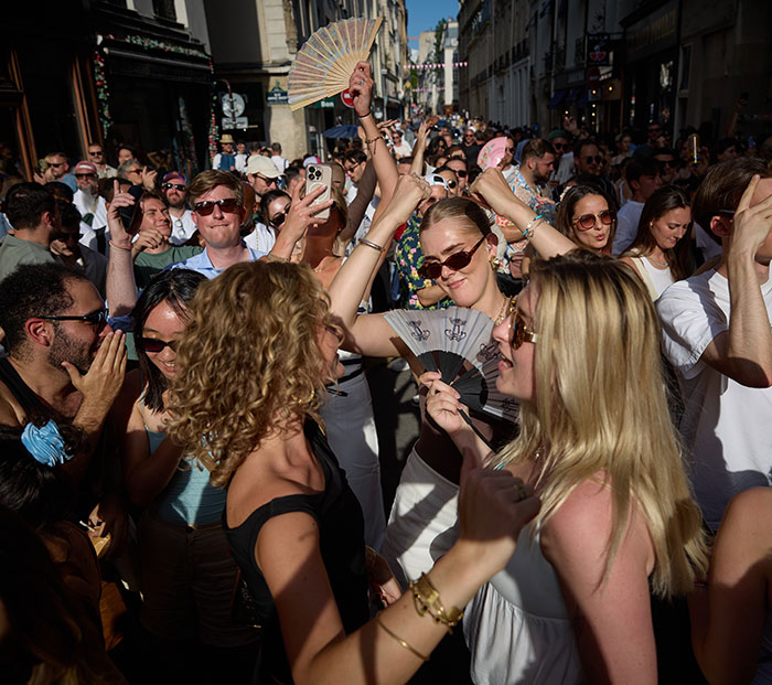 Crowd attending a popular music festival during daytime amid rising concerns about violence against women and syringe incidents.
