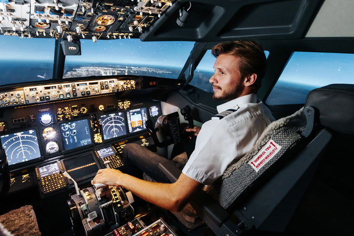 Pilot in cockpit monitoring flight instruments, highlighting aviation safety and flight attendant interaction. Pilot in cockpit monitoring flight instruments, highlighting aviation safety and flight attendant interaction.