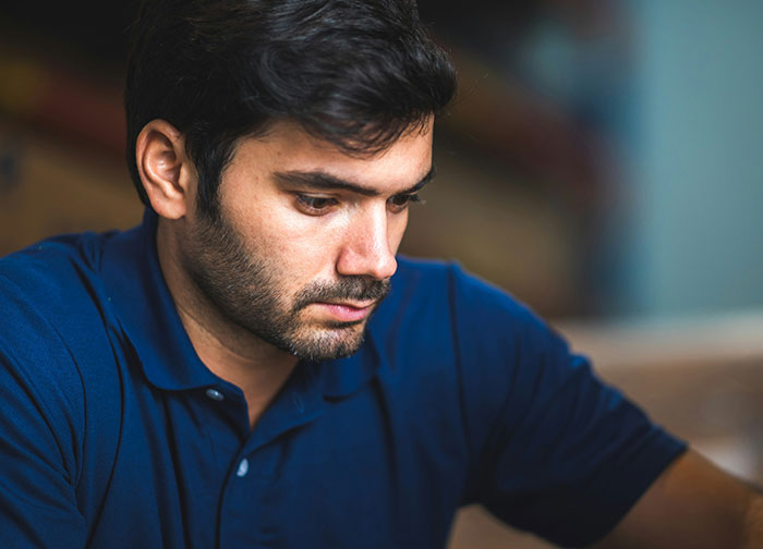 Man in blue shirt looking thoughtful and concerned, reflecting on wife obsessed with having more kids issue. Man in blue shirt looking thoughtful and concerned, reflecting on wife obsessed with having more kids issue.