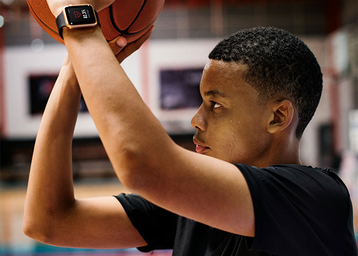 Teen boy holding basketball preparing to shoot, highlighting funny and inappropriate things kids have blurted out.