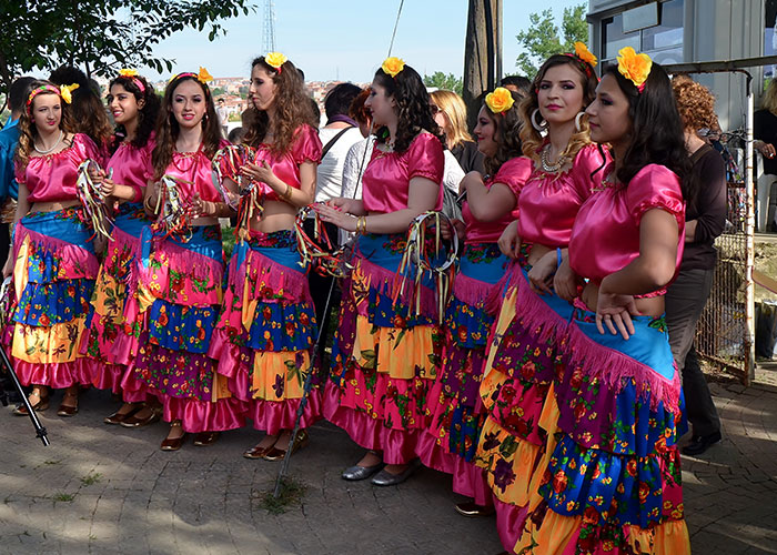 Group of women in colorful traditional dresses preparing to perform, reflecting the funniest and inappropriate things kids have blurted out.