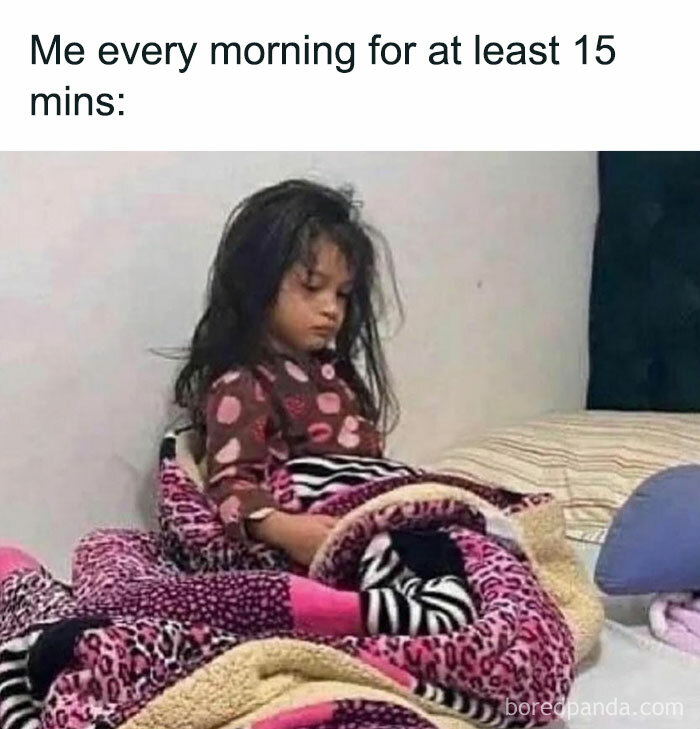 Young girl sitting tiredly wrapped in colorful blankets, illustrating sarcastic memes about morning mood and inner cynic feelings.