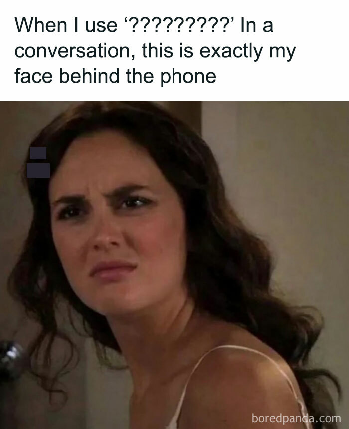 Woman making a confused and sarcastic face behind phone, matching hilariously sarcastic memes for inner cynic.