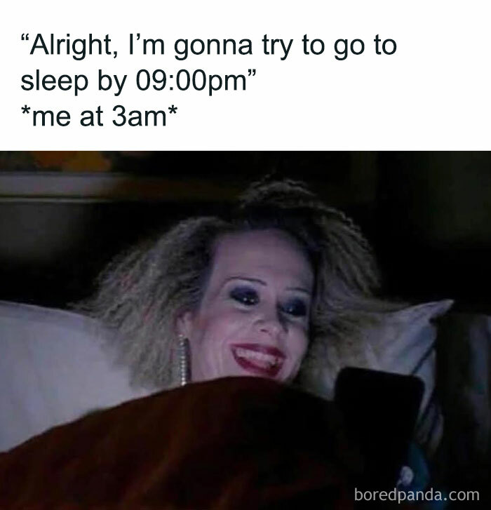 Woman with messy hair and heavy makeup smiling at phone in bed at 3am, a funny post perfect for sharing with friends.