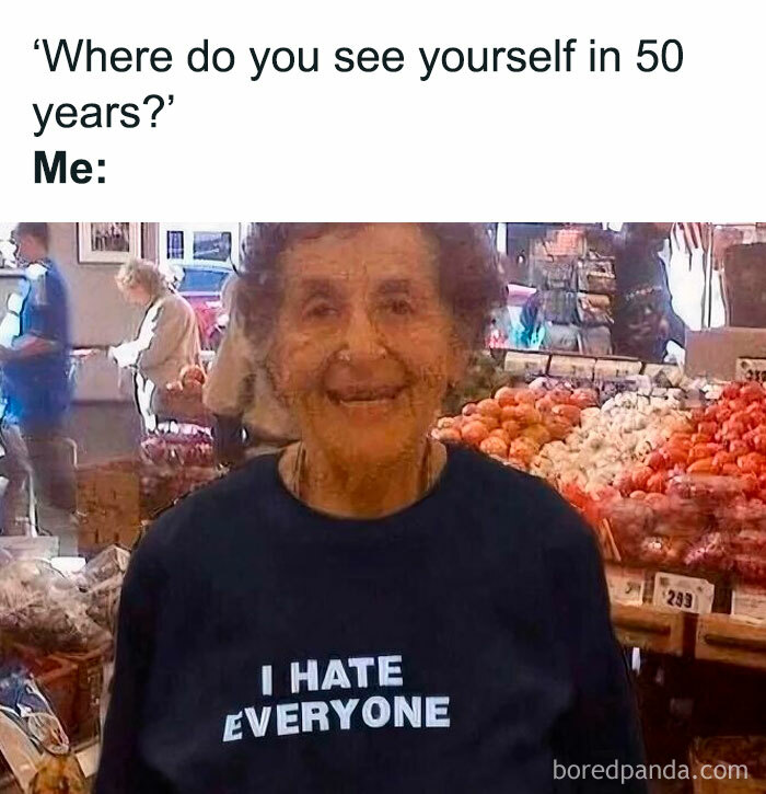Elderly woman smiling in market wearing a shirt that says I hate everyone, a funny meme about therapy costs.