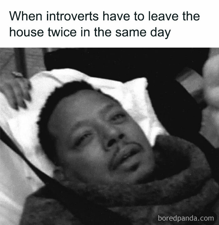 Exhausted man lying down with the caption about introverts leaving the house twice, highlighting everyday introvert life.