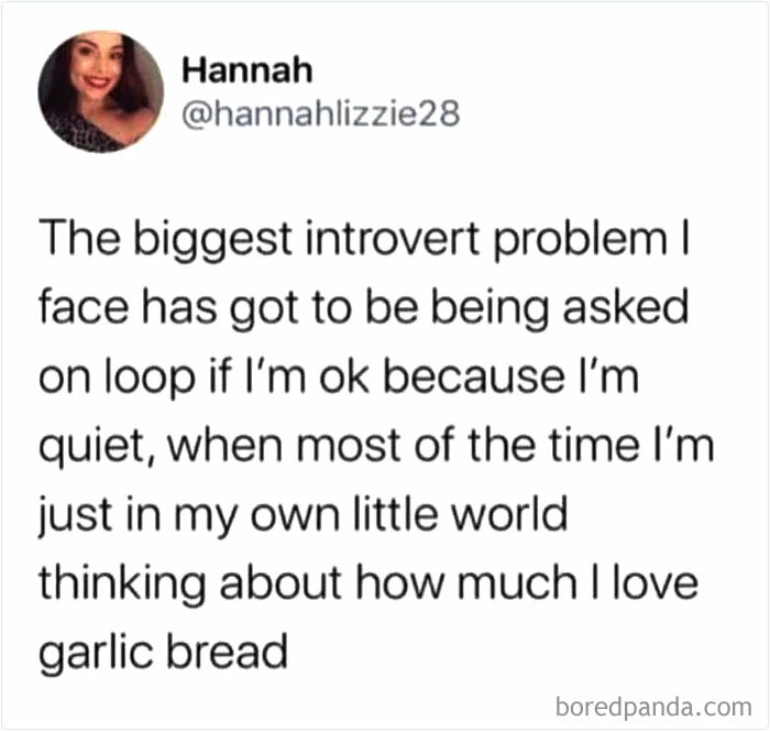 Tweet about introvert problems humorously highlighting quietness and love of garlic bread in relatable introvert memes.