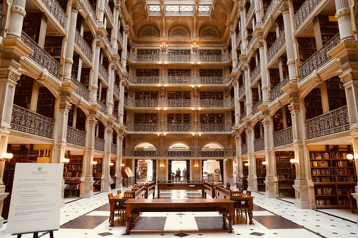 Impressive multi-level library interior with ornate columns and rows of books showcasing stunning architectural design.
