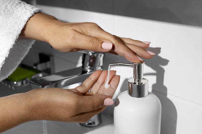 Person dispensing soap onto hands at a sink, illustrating concerns about younger generations' nose-diving abilities.