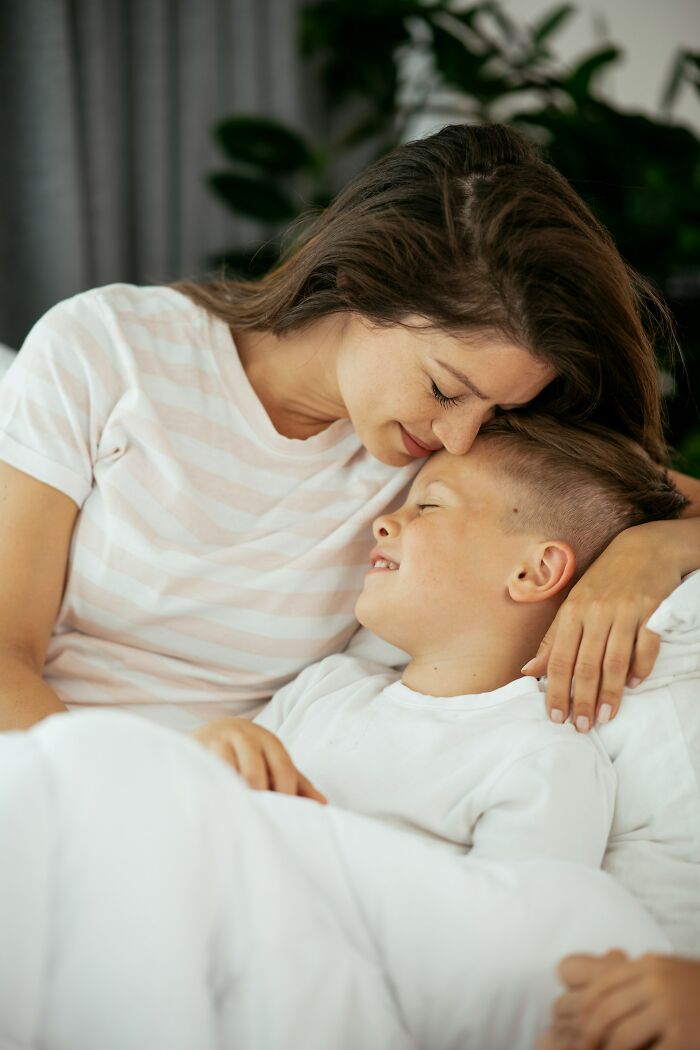 Mother gently embracing her smiling child, highlighting love and bonding in nurturing life partner relationships.