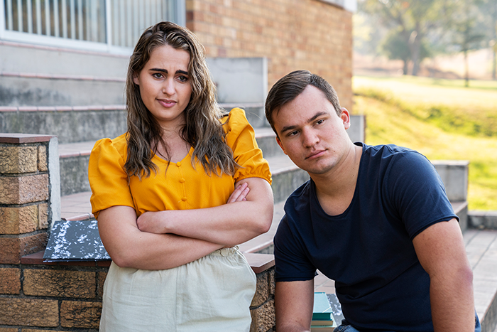 Young religious couple with serious expressions sitting outdoors, portraying tension related to babysitter payment dispute and Bible-based revenge plan. Young religious couple with serious expressions sitting outdoors, portraying tension related to babysitter payment dispute and Bible-based revenge plan.
