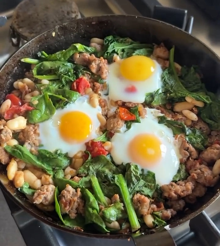 Skillet with eggs, spinach, sausage, and beans, related to Apple Martin roasting mom Gwyneth Paltrow in cooking post backlash. Skillet with eggs, spinach, sausage, and beans, related to Apple Martin roasting mom Gwyneth Paltrow in cooking post backlash.